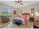 Spacious primary bedroom with coral accents and a sitting area at 38338 Timberlane Dr, Umatilla, FL 32784