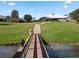 Wooden bridge leading to a lakefront property at 38338 Timberlane Dr, Umatilla, FL 32784