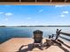 Relaxing lakeside dock with wooden chairs at 38338 Timberlane Dr, Umatilla, FL 32784