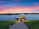 Evening view of a private lakefront dock at 38338 Timberlane Dr, Umatilla, FL 32784