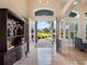 Bright entryway with open double doors, revealing a scenic view and tile flooring at 38338 Timberlane Dr, Umatilla, FL 32784