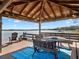 Covered lakeside gazebo with seating and lake views at 38338 Timberlane Dr, Umatilla, FL 32784