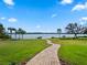 Brick pathway leading to a lakefront gazebo and dock at 38338 Timberlane Dr, Umatilla, FL 32784