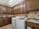 Laundry room with ample cabinetry and modern appliances at 38338 Timberlane Dr, Umatilla, FL 32784