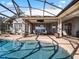 Stunning pool area with screened enclosure, providing shade and privacy at 38338 Timberlane Dr, Umatilla, FL 32784