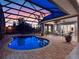 Inviting pool and spa with covered patio and sunset views at 38338 Timberlane Dr, Umatilla, FL 32784