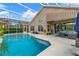 Enclosed pool with water views and adjacent patio furniture at 1234 Crown Pointe Ln, Ormond Beach, FL 32174