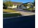 Single-story house with a paved driveway and landscaping at 130 Prima Dr, Kissimmee, FL 34759