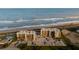 Aerial view of beachfront condo building and parking lot at 2222 Ocean Shore Blvd # 102B, Ormond Beach, FL 32176