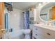Charming bathroom with white vanity and blue shower curtain at 2222 Ocean Shore Blvd # 102B, Ormond Beach, FL 32176