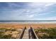 Wooden boardwalk leads to beautiful beach with ocean view at 2222 Ocean Shore Blvd # 102B, Ormond Beach, FL 32176