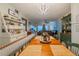 Dining area with a wooden table and built-in bench, overlooking the living room at 2222 Ocean Shore Blvd # 102B, Ormond Beach, FL 32176