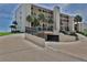 Building exterior with parking garage access at 2222 Ocean Shore Blvd # 102B, Ormond Beach, FL 32176