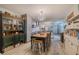 Kitchen features gray cabinets, white tile backsplash, and farm table at 2222 Ocean Shore Blvd # 102B, Ormond Beach, FL 32176