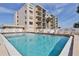 Community pool with surrounding lounge chairs at 2222 Ocean Shore Blvd # 102B, Ormond Beach, FL 32176