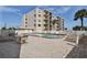 Community pool area with plenty of lounge chairs at 2222 Ocean Shore Blvd # 102B, Ormond Beach, FL 32176