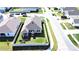 An aerial view of a fenced-in backyard with a green lawn, playground, and patio next to a two-story home at 4247 Little Owl Ln, Kissimmee, FL 34746
