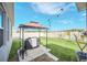 Backyard with gazebo, grill, and grassy area at 4247 Little Owl Ln, Kissimmee, FL 34746
