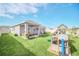 Large backyard with playset and covered patio at 4247 Little Owl Ln, Kissimmee, FL 34746