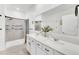 Clean bathroom with double vanity, large mirror, and walk-in shower at 4247 Little Owl Ln, Kissimmee, FL 34746