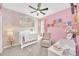 Charming Bedroom with pink walls and white crib at 4247 Little Owl Ln, Kissimmee, FL 34746