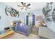 bedroom with Star Wars decor, built-in shelving, and a twin bed at 4247 Little Owl Ln, Kissimmee, FL 34746