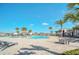 Resort-style pool with lounge chairs and palm trees at 4247 Little Owl Ln, Kissimmee, FL 34746