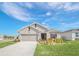 Newly built home with landscaped front yard, driveway and two car garage at 4247 Little Owl Ln, Kissimmee, FL 34746