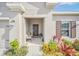 Covered front porch with seating area, adding to the home's curb appeal at 4247 Little Owl Ln, Kissimmee, FL 34746