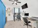 Home office with two workstations and blue accent wall at 4247 Little Owl Ln, Kissimmee, FL 34746