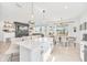 Open concept kitchen with white island and breakfast bar, stainless steel appliances at 4247 Little Owl Ln, Kissimmee, FL 34746