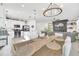 Open concept kitchen with island, stainless steel appliances, and white cabinetry at 4247 Little Owl Ln, Kissimmee, FL 34746