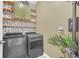 Laundry room with washer, dryer, and shelving at 4247 Little Owl Ln, Kissimmee, FL 34746