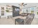 Open concept living room with fireplace, sectional sofa and built-in shelving at 4247 Little Owl Ln, Kissimmee, FL 34746