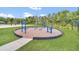 Outdoor fitness park features blue exercise equipment on a bed of mulch surrounded by a green lawn at 4247 Little Owl Ln, Kissimmee, FL 34746