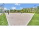 Sand volleyball court with net and surrounding grass at 4247 Little Owl Ln, Kissimmee, FL 34746