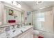 Updated bathroom with white cabinets, quartz countertop, and a walk-in shower at 5700 E Fort King St, Ocala, FL 34470