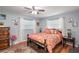 Spacious bedroom with a queen-size bed, ceiling fan, and ample closet space at 5700 E Fort King St, Ocala, FL 34470