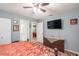 Comfortable bedroom with a queen bed, dresser, and access to a second bathroom at 5700 E Fort King St, Ocala, FL 34470