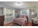 Cozy bedroom with a double bed and two windows at 5700 E Fort King St, Ocala, FL 34470
