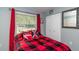 Bright bedroom with red bedding and built-in closet at 5700 E Fort King St, Ocala, FL 34470