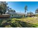 Light green house with nicely landscaped lawn at 5700 E Fort King St, Ocala, FL 34470