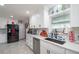 White kitchen with stainless steel appliances and quartz countertops at 5700 E Fort King St, Ocala, FL 34470