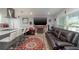 Cozy living room with a fireplace, large TV, and comfortable leather seating at 5700 E Fort King St, Ocala, FL 34470