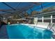 Inviting screened pool with patio furniture, ready for relaxation at 5700 E Fort King St, Ocala, FL 34470