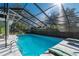 Relaxing screened-in pool with patio furniture at 5700 E Fort King St, Ocala, FL 34470