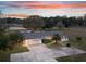 Aerial sunset view of home, showcasing the driveway and landscaping at 1045 Carter Rd, Deland, FL 32724