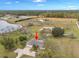 Aerial view showcasing the home, its setting, and nearby lake at 1045 Carter Rd, Deland, FL 32724