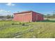 Large red barn with sliding doors and metal siding at 1045 Carter Rd, Deland, FL 32724