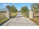 Long driveway leading to house with stone pillars and lion statues at 1045 Carter Rd, Deland, FL 32724